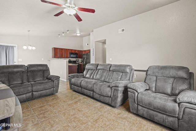 14215 Otter Point Ct, El Paso, TX 79938 - living room with a ceiling fan, light tile patterned flooring, and a chandelier