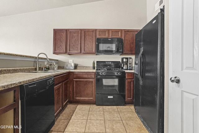 14215 Otter Point Ct, El Paso, TX 79938 - kitchen with black appliances, light tile patterned flooring, and light countertops