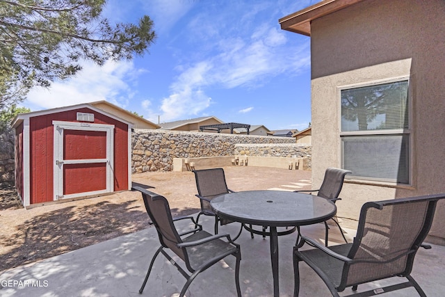 14215 Otter Point Ct, El Paso, TX 79938 - fenced backyard with a patio, a storage shed, and outdoor dining area