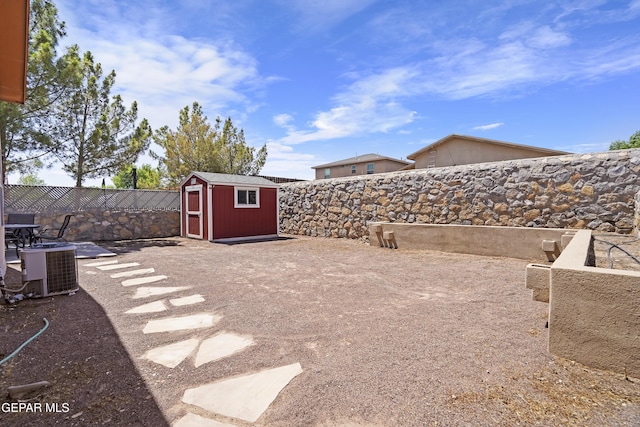 14215 Otter Point Ct, El Paso, TX 79938 - fenced backyard with a storage unit and a patio area