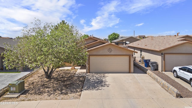 14215 Otter Point Ct, El Paso, TX 79938 - view of front of home with concrete driveway, a garage, and stucco siding