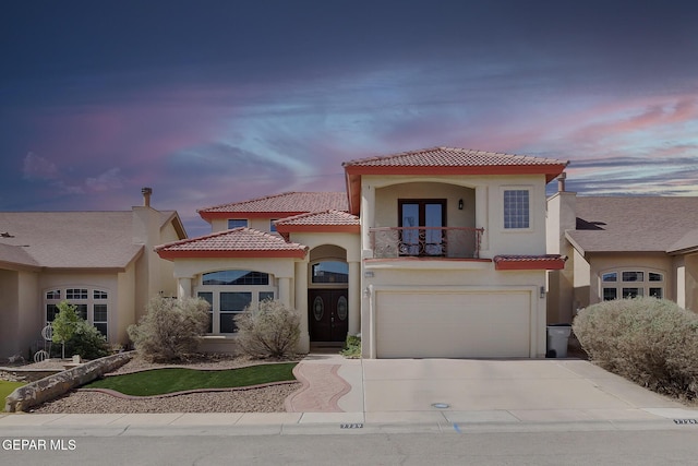 7729 Bartlett Landing Ct, El Paso, TX 79912 - mediterranean / spanish house featuring a balcony, french doors, driveway, and stucco siding