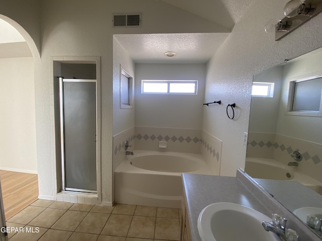 1409 Rainbow Ridge Dr, El Paso, TX 79912 - full bath with a bath, healthy amount of natural light, tile patterned flooring, and a textured wall