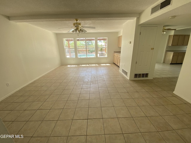 1409 Rainbow Ridge Dr, El Paso, TX 79912 - empty room with ceiling fan, light tile patterned flooring, and a textured ceiling