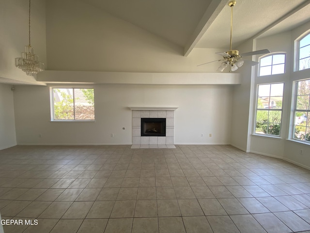 1409 Rainbow Ridge Dr, El Paso, TX 79912 - unfurnished living room with high vaulted ceiling, tile patterned flooring, a fireplace, a ceiling fan, and a chandelier