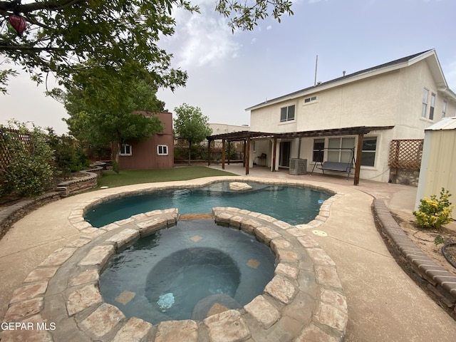 1409 Rainbow Ridge Dr, El Paso, TX 79912 - view of pool with an outdoor structure, a pool with connected hot tub, a fenced backyard, and a patio