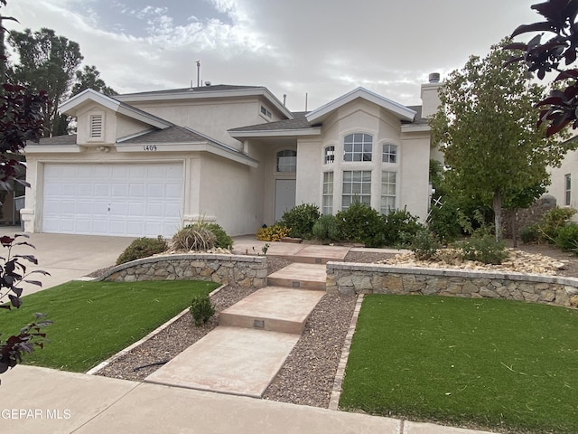 1409 Rainbow Ridge Dr, El Paso, TX 79912 - view of front of property featuring stucco siding, driveway, a front lawn, a chimney, and a garage