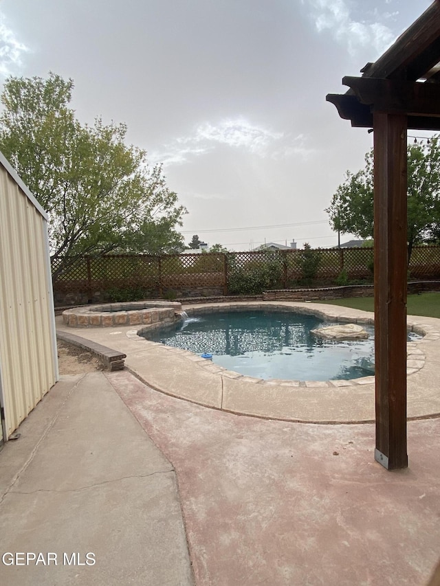 1409 Rainbow Ridge Dr, El Paso, TX 79912 - view of swimming pool with a fenced backyard, a patio, and a pool with connected hot tub