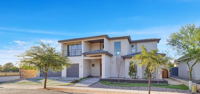 525 Cotton Blossom Ave, El Paso, TX 79922 - view of front facade featuring an attached garage, driveway, a tile roof, stucco siding, and a balcony