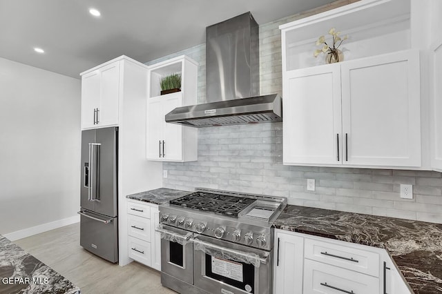 525 Cotton Blossom Ave, El Paso, TX 79922 - kitchen featuring high quality appliances, wall chimney exhaust hood, tasteful backsplash, white cabinets, and recessed lighting