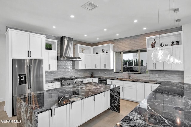 525 Cotton Blossom Ave, El Paso, TX 79922 - kitchen featuring wall chimney exhaust hood, stainless steel appliances, open shelves, dark stone counters, and tasteful backsplash