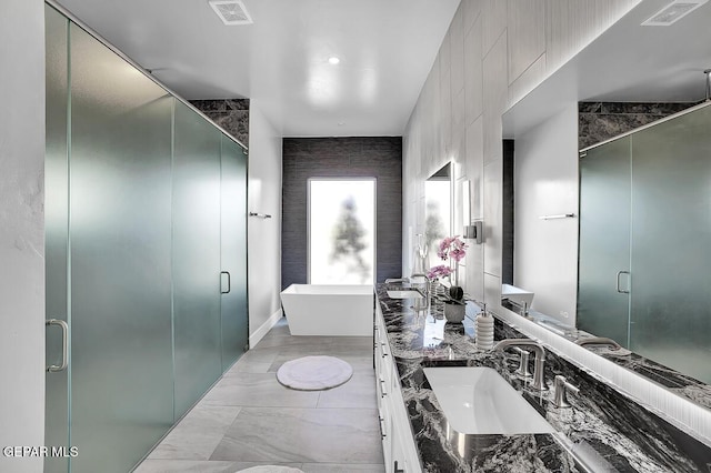 525 Cotton Blossom Ave, El Paso, TX 79922 - full bathroom with double vanity, a freestanding bath, and a stall shower