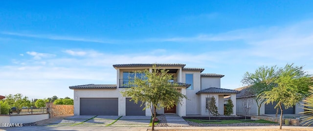 525 Cotton Blossom Ave, El Paso, TX 79922 - mediterranean / spanish-style house featuring driveway, a tiled roof, a balcony, stucco siding, and an attached garage