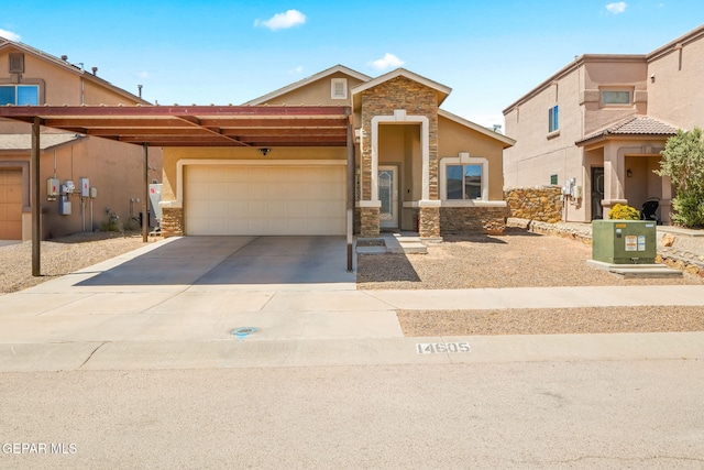 14605 Spanish Point Dr, El Paso, TX 79938 - view of front of home featuring stone siding, an attached garage, driveway, and stucco siding