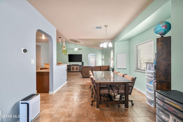 14605 Spanish Point Dr, El Paso, TX 79938 - dining area featuring arched walkways, a chandelier, and lofted ceiling