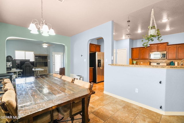 14605 Spanish Point Dr, El Paso, TX 79938 - dining room featuring arched walkways and a chandelier