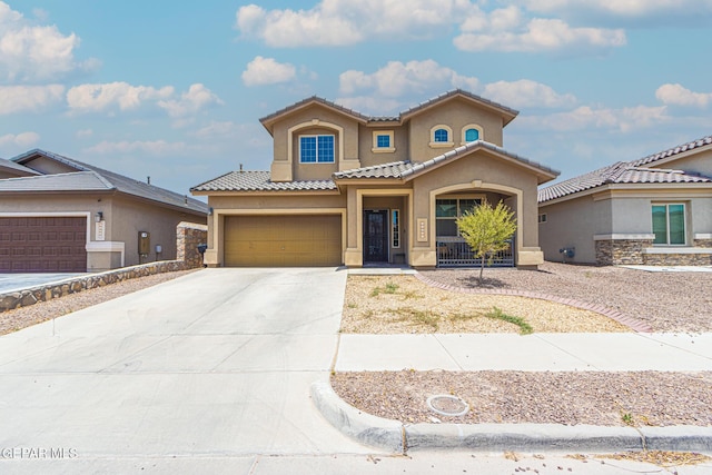 12355 Joe Gomez, El Paso, TX 79928 - mediterranean / spanish-style house with stucco siding, concrete driveway, a tile roof, and a garage