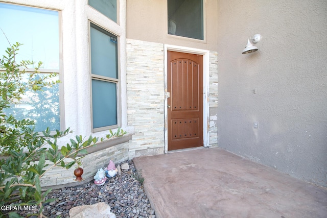 1465 Fito Hernandez St, El Paso, TX 79928 - view of exterior entry featuring stucco siding and stone siding