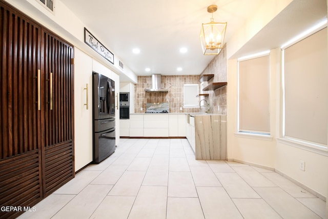 1465 Fito Hernandez St, El Paso, TX 79928 - kitchen featuring refrigerator with ice dispenser, wall chimney range hood, oven, light countertops, and decorative backsplash