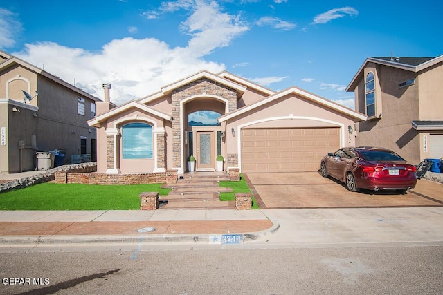 11344 Acoma St, El Paso, TX 79934 - view of front of house with stone siding, an attached garage, driveway, stucco siding, and a front lawn