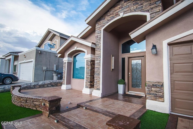 11344 Acoma St, El Paso, TX 79934 - view of exterior entry featuring stone siding, stucco siding, and an attached garage