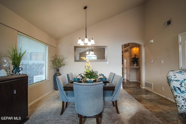 11344 Acoma St, El Paso, TX 79934 - dining room with arched walkways, a chandelier, stone finish floors, and high vaulted ceiling