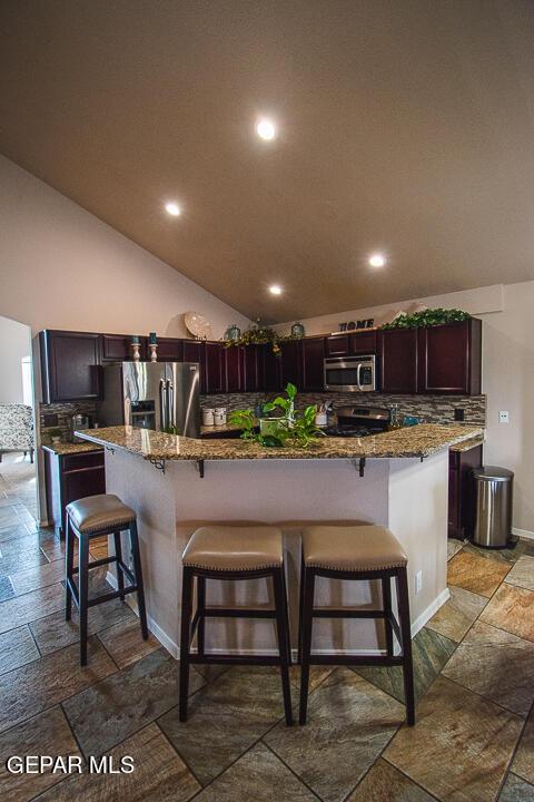 11344 Acoma St, El Paso, TX 79934 - kitchen with stainless steel appliances, stone tile floors, recessed lighting, stone countertops, and tasteful backsplash