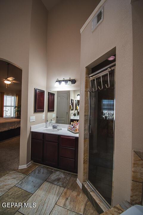 11344 Acoma St, El Paso, TX 79934 - full bathroom with ensuite bathroom, a towering ceiling, vanity, a shower stall, and a ceiling fan