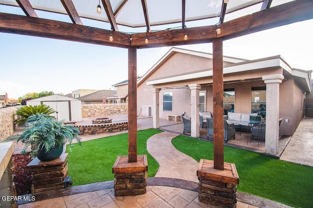 11344 Acoma St, El Paso, TX 79934 - fenced backyard featuring outdoor lounge area, a storage shed, a gazebo, and a patio area