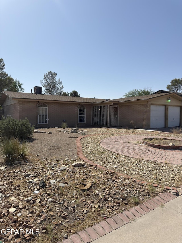 3376 Guthrie St, El Paso, TX 79935 - single story home with brick siding, a garage, and driveway