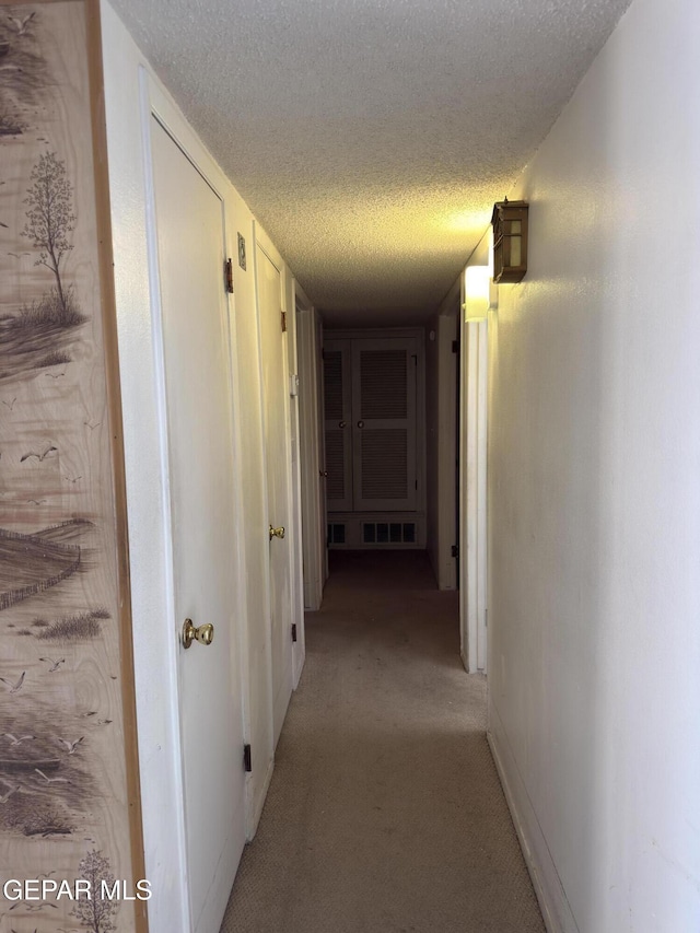 3376 Guthrie St, El Paso, TX 79935 - hall featuring light colored carpet and a textured ceiling