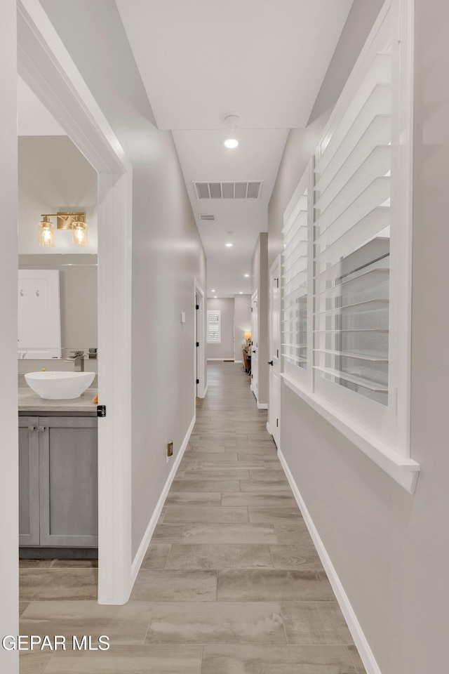737 Al Smith Ln, El Paso, TX 79932 - hallway with a sink and light wood finished floors