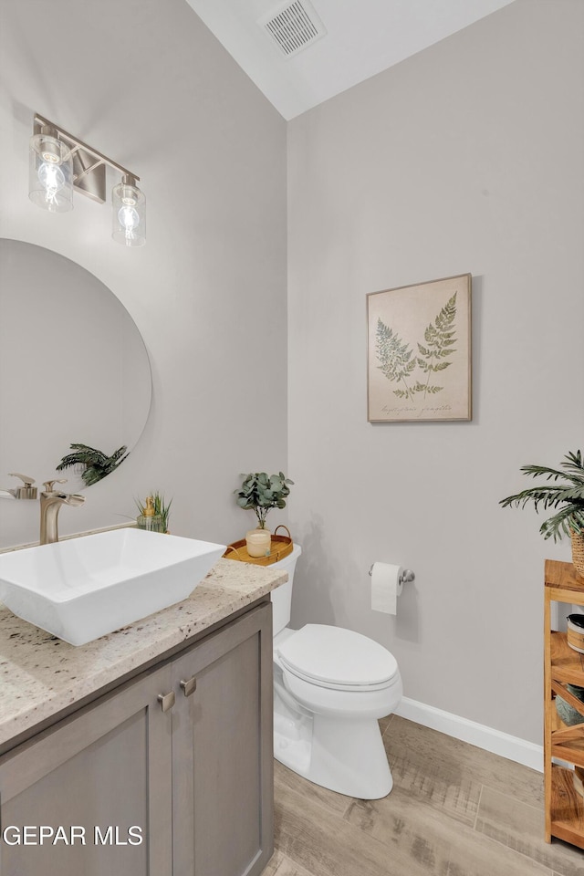 737 Al Smith Ln, El Paso, TX 79932 - half bathroom featuring vanity and wood finished floors