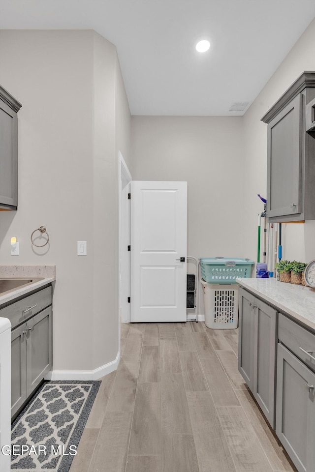 737 Al Smith Ln, El Paso, TX 79932 - kitchen featuring gray cabinetry and light wood-style flooring