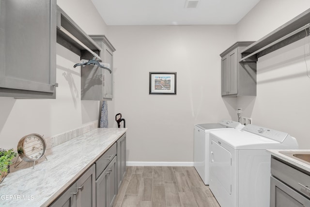 737 Al Smith Ln, El Paso, TX 79932 - laundry area with cabinet space, independent washer and dryer, and light wood finished floors