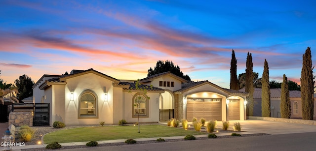 737 Al Smith Ln, El Paso, TX 79932 - mediterranean / spanish-style home featuring concrete driveway, an attached garage, stucco siding, and a front lawn