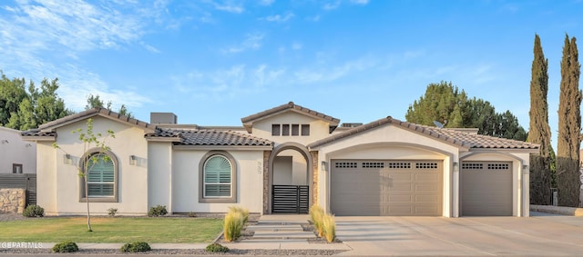 737 Al Smith Ln, El Paso, TX 79932 - mediterranean / spanish-style house featuring an attached garage, driveway, stucco siding, and a tile roof