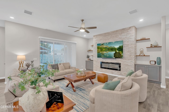 737 Al Smith Ln, El Paso, TX 79932 - living room with a ceiling fan, light wood finished floors, a stone fireplace, and recessed lighting