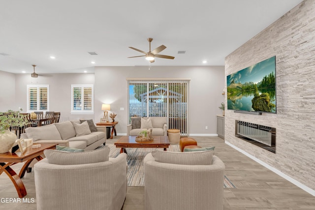 737 Al Smith Ln, El Paso, TX 79932 - living room featuring a ceiling fan, a stone fireplace, and recessed lighting