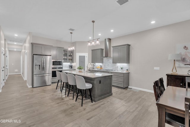 737 Al Smith Ln, El Paso, TX 79932 - kitchen featuring appliances with stainless steel finishes, wall chimney range hood, gray cabinetry, light countertops, and recessed lighting