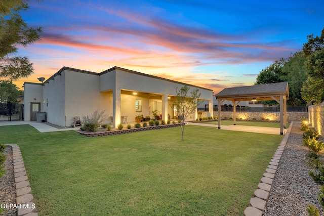 737 Al Smith Ln, El Paso, TX 79932 - yard at dusk with a patio, a fenced backyard, and a gazebo