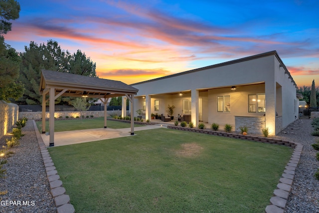 737 Al Smith Ln, El Paso, TX 79932 - back of house with stucco siding, a ceiling fan, a patio, and stone siding