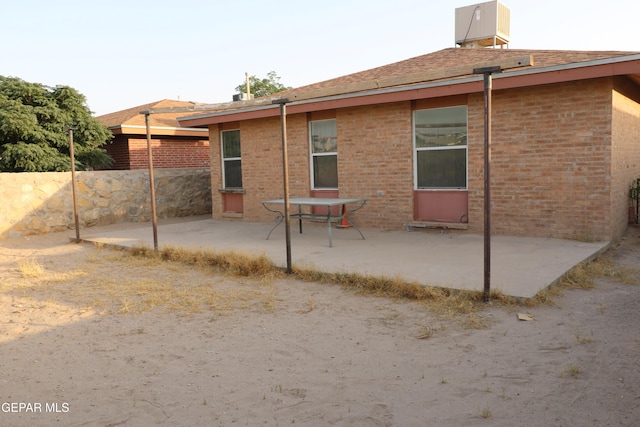 9421 Ariel Rico Ct, El Paso, TX 79907 - rear view of property featuring a patio, brick siding, and a shingled roof