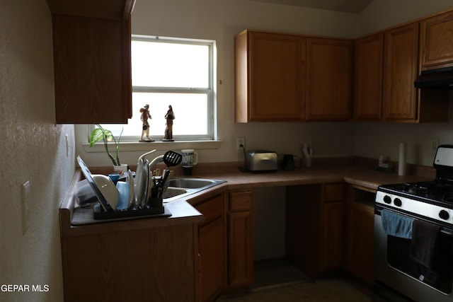 9421 Ariel Rico Ct, El Paso, TX 79907 - kitchen featuring range with gas stovetop, under cabinet range hood, light countertops, and brown cabinetry