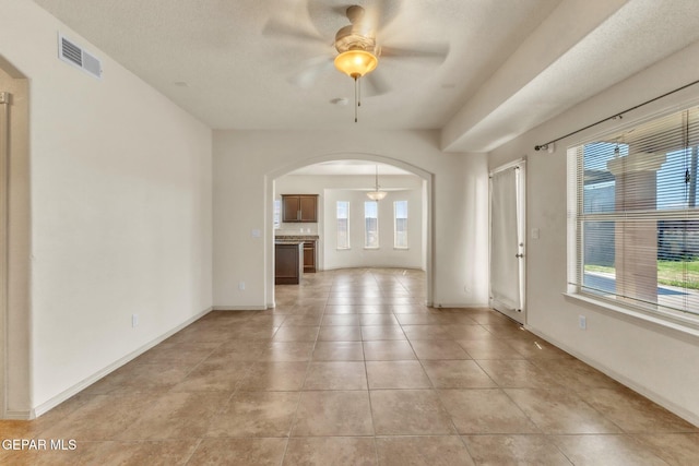 14330 Woods Point Ave, El Paso, TX 79938 - empty room featuring ceiling fan, arched walkways, and light tile patterned floors