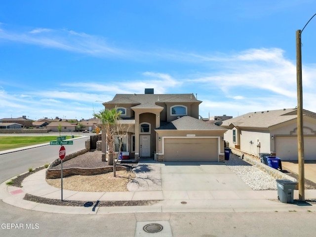 14330 Woods Point Ave, El Paso, TX 79938 - view of front facade featuring driveway, a garage, and stucco siding