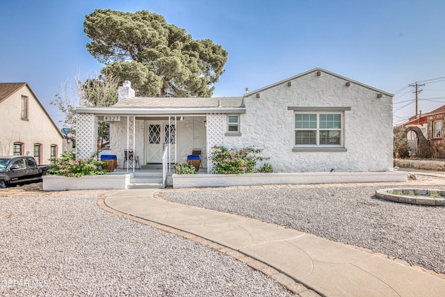 4327 Oxford Ave, El Paso, TX 79903 - view of front facade with covered porch, stucco siding, and a chimney
