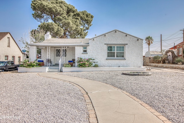 4327 Oxford Ave, El Paso, TX 79903 - view of front of property featuring covered porch, a chimney, and stucco siding