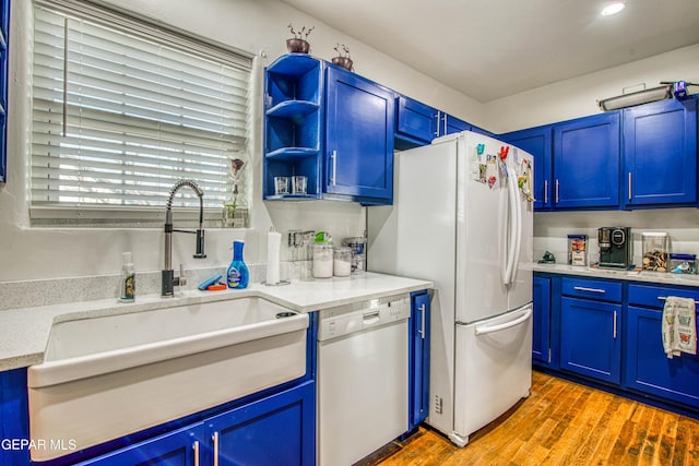 4327 Oxford Ave, El Paso, TX 79903 - kitchen featuring white appliances, light wood-style floors, blue cabinets, light countertops, and open shelves