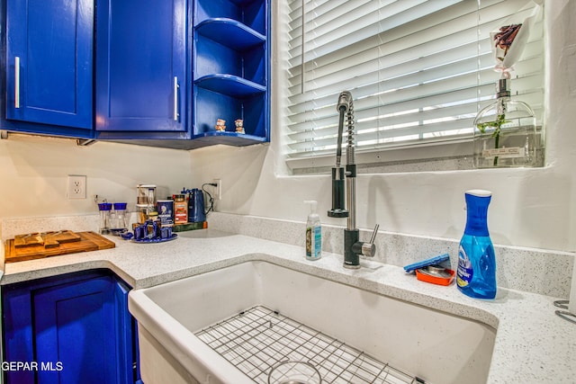 4327 Oxford Ave, El Paso, TX 79903 - kitchen featuring blue cabinets, light countertops, and open shelves